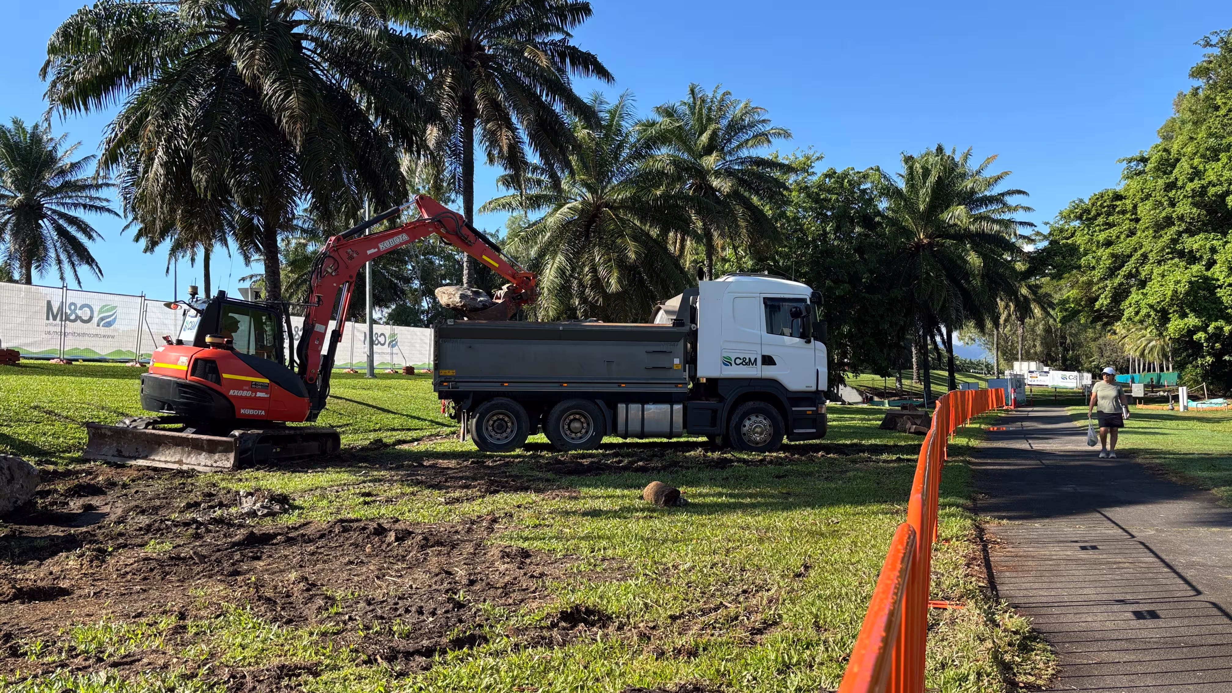 Excavator and truck activity during early ground works at Port Douglas footpath upgrade site